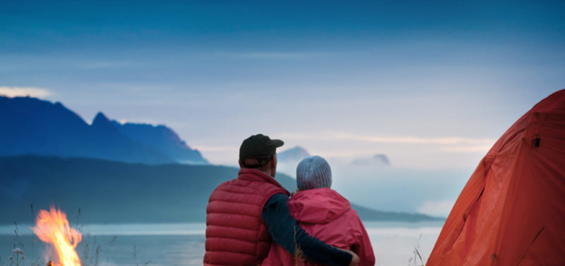 couple with tent near seaside